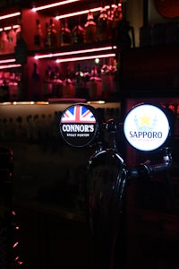 a bar with a red neon sign